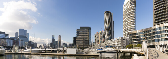 Docklands, Melbourne, Victoria, Australia. Waterfront buildings and marina, water and glass sparkling in sunshine.