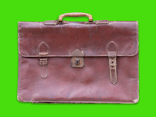 Old leather bag isolated on green background.