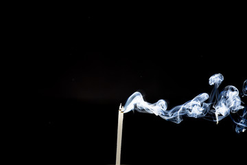 Movement of smoke from  joss stick on black background, Abstract  from smoke on black.