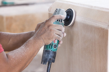 workers hands at carpenter workspace refining the surface of woo