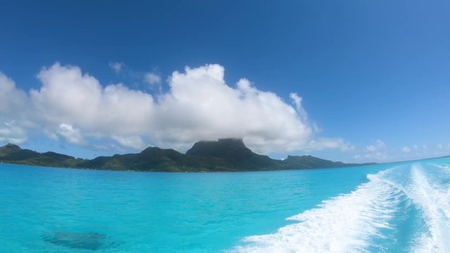 Sailing around blue lagoon and Otemanu mountain at Bora Bora island, Tahiti, French Polynesia (view from action camera)
