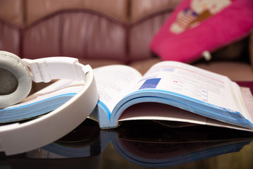 Books and headphones are placed on the reception desk.