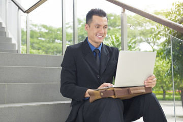 Close up view of asian businessman with laptop