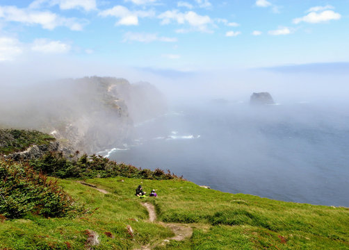 Admiring the beautiful sights of the Skerwink trail outside of Trinity, along the rugged coasts of Newfoundland and Labrador, Canada