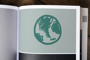 Green globe drawing on a magazine