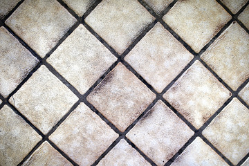 Background of Small Square Tan Floor Tiles in a Diagonal Pattern