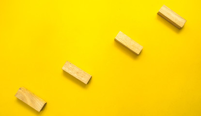 wooden block stack on yellow background