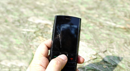 Broken mobile phone in hand