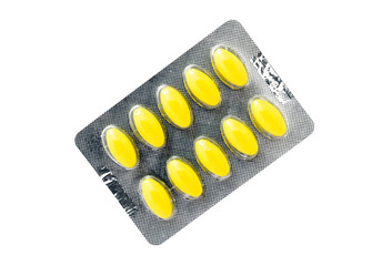 A panel of yellow capsules medicine isolated on a white background, Yellow pills