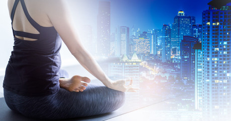 Naklejka premium Young woman practicing yoga in color background.Young people do yoga indoor for therapy her life style.Close up hands in meditating gesture. back to nature concept