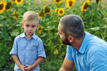 Frustrated, the son and the father . Father calms son for a walk