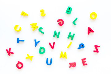 Alphabet for kids concept.  English letters in disorder on white background top view