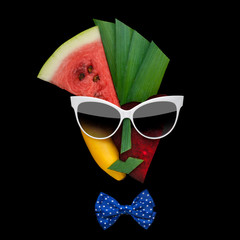 Tasty art / Creative concept photo of cubist style female face in sunglasses made of fruits and...