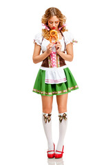 Oktoberfest / Creative concept photo of Oktoberfest waitress wearing a traditional Bavarian costume with pretzels isolated on white background.