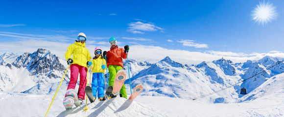 Happy family enjoying winter vacations in mountains . Ski, Sun, Snow and fun.