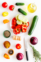 Healthy food concept. Ingredients for vegetable stew. Squash, bell pepper, tomato, spices, oil on white background top view