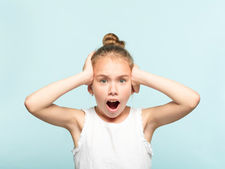 omg unbelievable shock amazement. dumbfounded child clutching her head with hands. portrait of a...