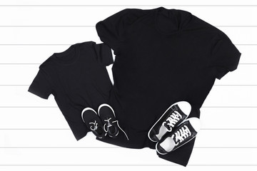 Child and adult black t-shirt on a white background