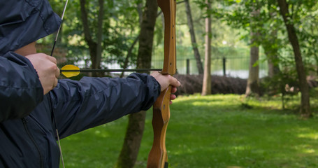 the man in the hood, pulled the bowstring, for a further shot from the bow to the target