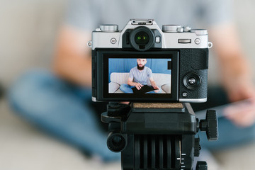 content creation for social media. image of a bearded man shooting video of himself on camera...