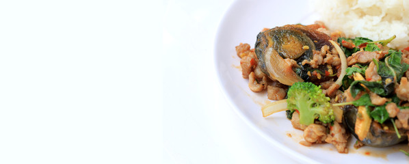 Stir-fried basil leave with minced pork, chicken, fried preserved egg and carrot, yellow corn, Broccoli with rice and fried egg in white dish on white background. Thai style food.