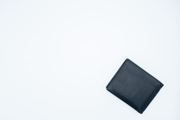 A black leather wallet rests on a white background.