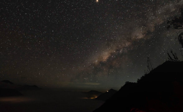 Beautiful view of milky way and silhouette trees on the way to Kawah Ijen in Java, Indonesia.
