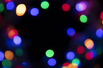 The colors of the lights are flashing blue, green, purple and orange in the form of Bokeh.