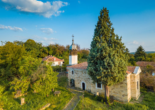 Small Eastern Orthodox church in a small Bulgarian village - a place for worship and relaxation under the first rays of the rising sun