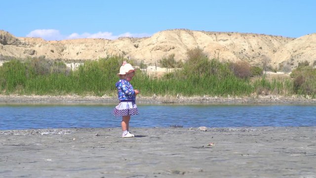 the child stands at the lake