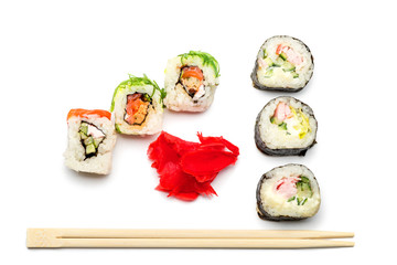 Food abstract background. On the white plane lie rolls or sushi, ginger plates and sticks for sushi.