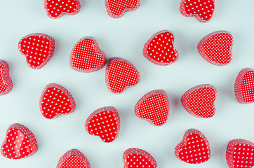 Playful red hearts on fashion mint pastel color background. Modern holiday Valentine's day backdrop.