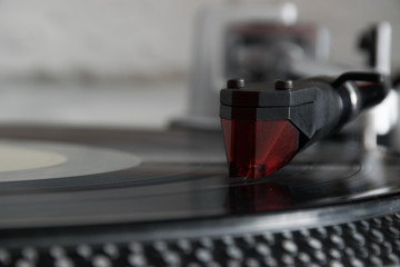 Vinyl record with needle on turntable