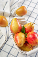 organic pears laying down on a lightly dotted kitchen cloth