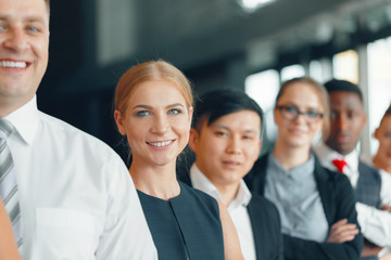 Fototapeta premium Successful team of young perspective businesspeople in office