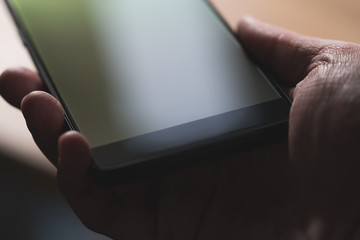young man hand hold smartphone close-up
