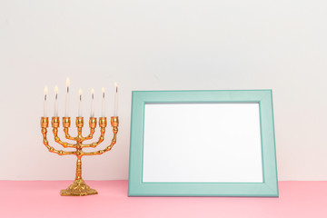 Bronze Hanukkah menorah with burning candles