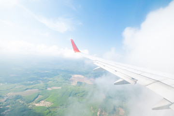 Aircraft wing flying view from window of nature in the morning. Traveling concept. Wing of an aircraft.