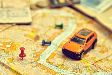 travel concept - small toy car on the map