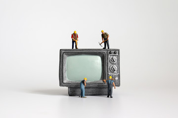 A miniature television and miniatures workers.