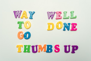 Way to go, Well done, thumbs up words in colorful letters on white background