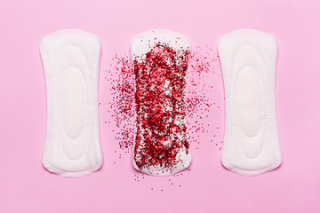 Women's hygiene products on a pink background. Concept of critical days,  menstruation