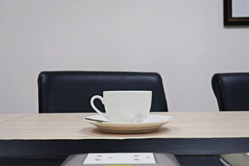 Fototapeta na wymiar coffee cup on wooden table in meeting room