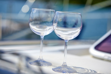 Pair of wineglasses against the yacht