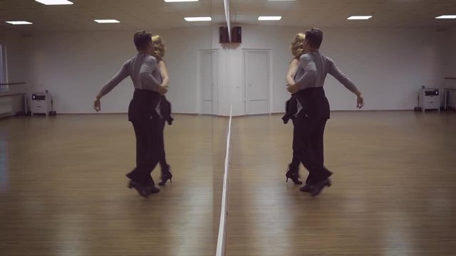 Man and a woman are dancing in the studio