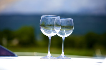 Pair of wineglasses against the yacht