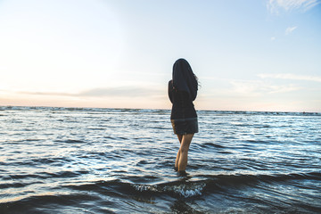 The woman in black looks at the sea, grief and a depression