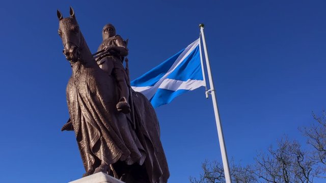 The Scottish flag flying behind the statue of Robert the Bruce at Bannockburn.