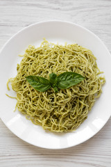 Plate of pasta spaghetti with pesto sauce, overhead. From above, flat lay. Close-up.