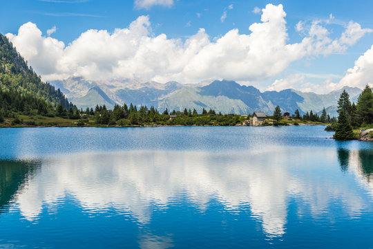 Cloud reflecting on the Aviolo Lake in a summer day